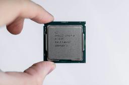 person holding Intel processor